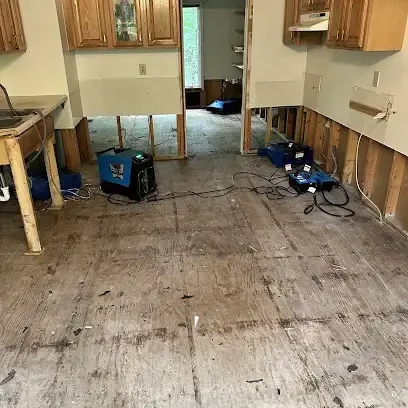 Kitchen with the flooring taken up and air movers aimed along the lower cabinets