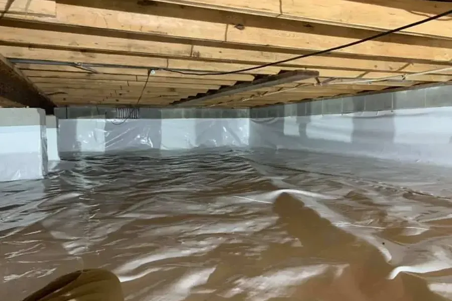 Rainwater pooled on the vapor barrier under a raised floor
