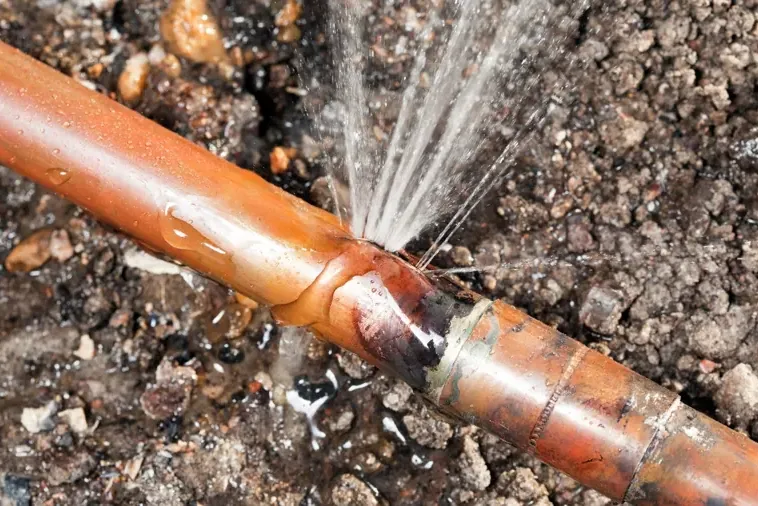 Leaking supply pipe exposed beneath a concrete slab foundation